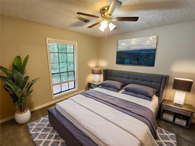 unfurnished bedroom with a closet, ceiling fan, carpet flooring, and a textured ceiling