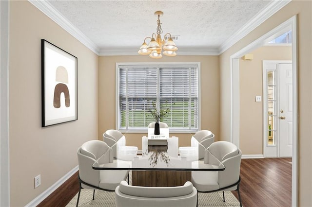 1039 Megan Ct, Sugar Hill, GA 30518 - dining area featuring a chandelier, dark wood-type flooring, crown molding, baseboards, and a textured ceiling