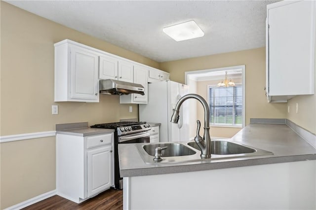 1039 Megan Ct, Sugar Hill, GA 30518 - kitchen featuring under cabinet range hood, gas stove, a sink, dark wood finished floors, and white cabinetry