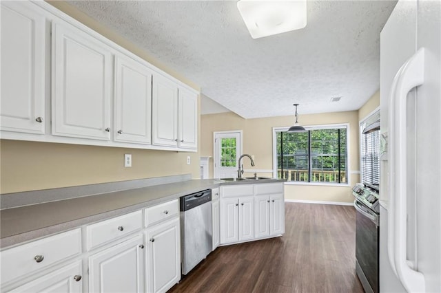 1039 Megan Ct, Sugar Hill, GA 30518 - kitchen featuring appliances with stainless steel finishes, a sink, dark wood-type flooring, a textured ceiling, and white cabinets