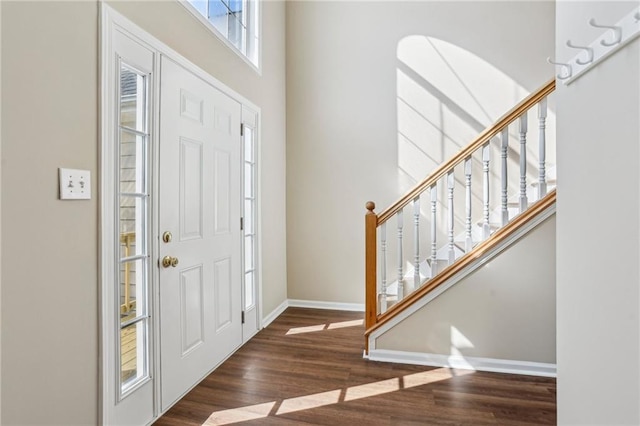 1039 Megan Ct, Sugar Hill, GA 30518 - foyer entrance with wood finished floors, baseboards, stairs, and a towering ceiling