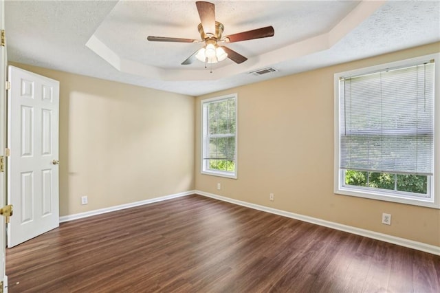 1039 Megan Ct, Sugar Hill, GA 30518 - empty room featuring a tray ceiling, baseboards, dark wood-type flooring, and ceiling fan