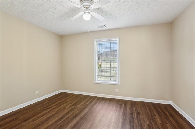 1039 Megan Ct, Sugar Hill, GA 30518 - unfurnished room with dark wood finished floors, baseboards, a textured ceiling, and a ceiling fan