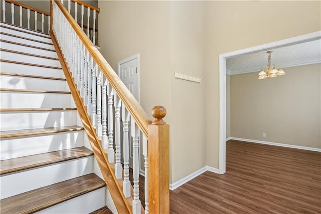 1039 Megan Ct, Sugar Hill, GA 30518 - staircase with baseboards, wood finished floors, a chandelier, and crown molding