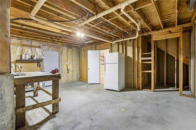 1039 Megan Ct, Sugar Hill, GA 30518 - unfinished below grade area featuring freestanding refrigerator and a workshop area
