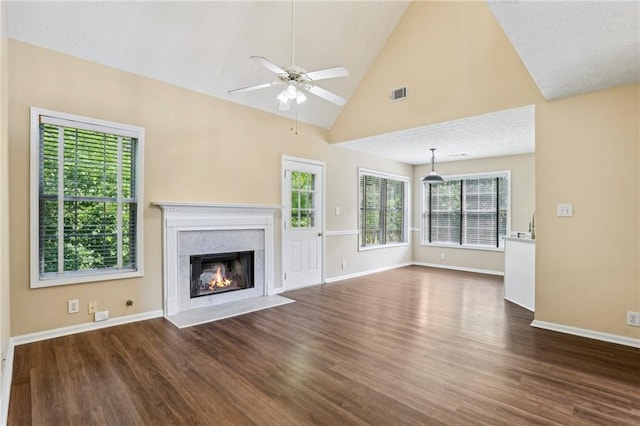 1039 Megan Ct, Sugar Hill, GA 30518 - unfurnished living room with wood finished floors, ceiling fan, baseboards, a premium fireplace, and high vaulted ceiling