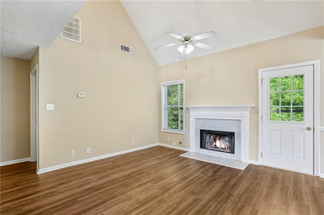 1039 Megan Ct, Sugar Hill, GA 30518 - unfurnished living room featuring wood finished floors, plenty of natural light, ceiling fan, baseboards, and high vaulted ceiling