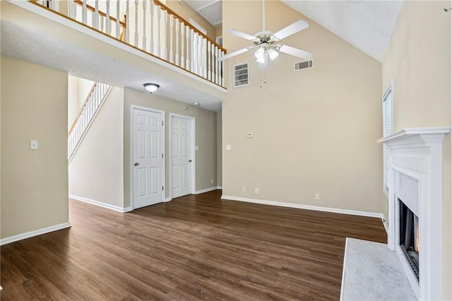 1039 Megan Ct, Sugar Hill, GA 30518 - unfurnished living room with ceiling fan, high vaulted ceiling, a fireplace with flush hearth, baseboards, and wood finished floors