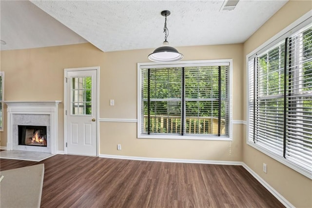1039 Megan Ct, Sugar Hill, GA 30518 - unfurnished dining area featuring wood finished floors, a textured ceiling, healthy amount of natural light, and baseboards