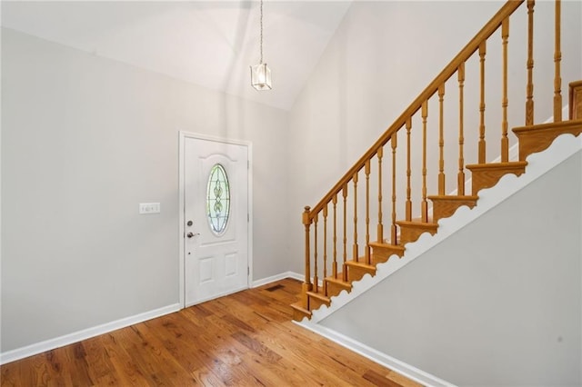 entryway featuring light hardwood / wood-style flooring and lofted ceiling