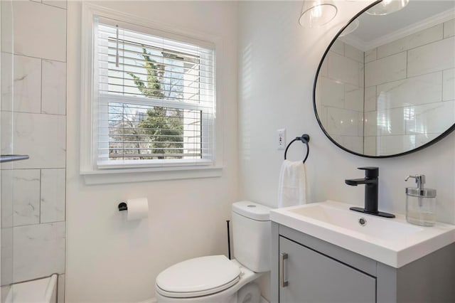 full bathroom featuring vanity, crown molding, and toilet