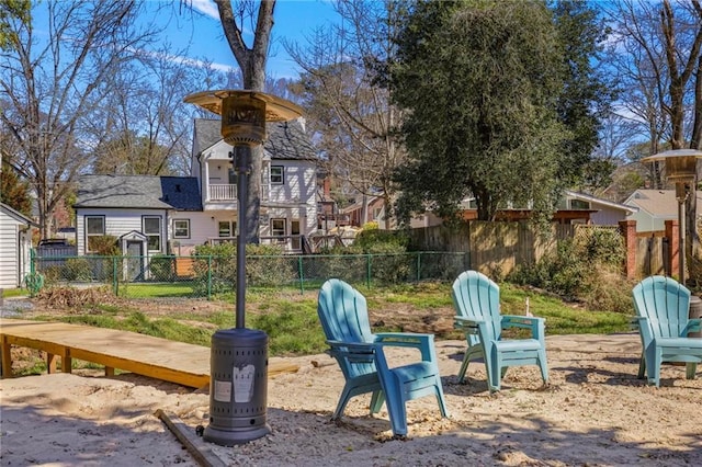 view of yard featuring a balcony and fence