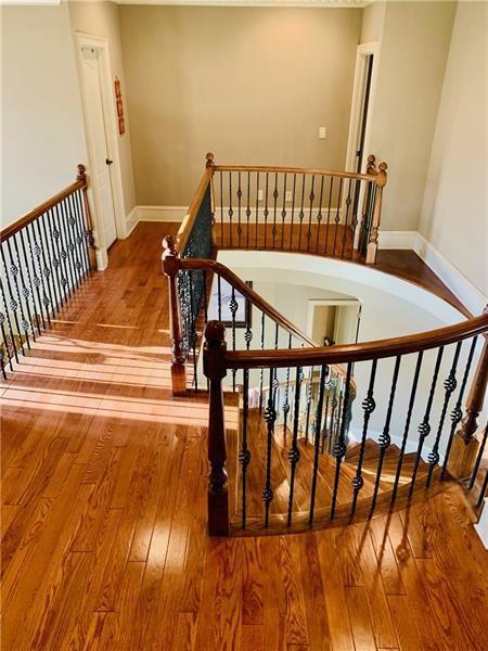 staircase with hardwood / wood-style flooring