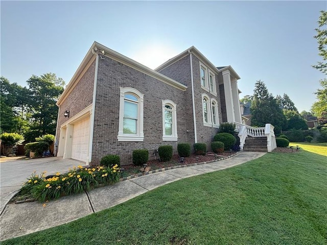 view of front facade with a garage and a front lawn