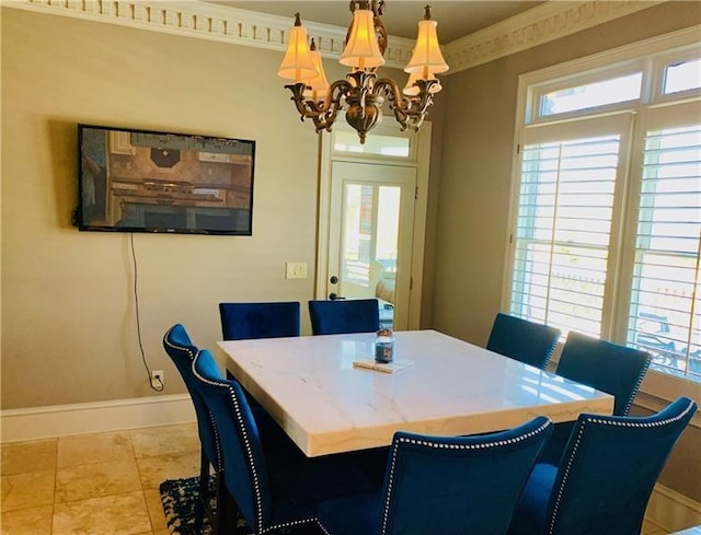 dining space featuring ornamental molding, a wealth of natural light, and a notable chandelier