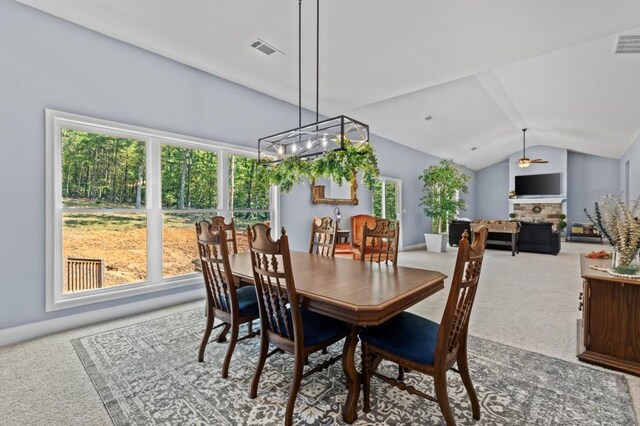 dining space featuring vaulted ceiling, ceiling fan, and carpet floors