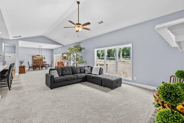 carpeted living room with vaulted ceiling and ceiling fan