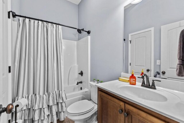 full bathroom with vanity, toilet, and shower / bathtub combination with curtain