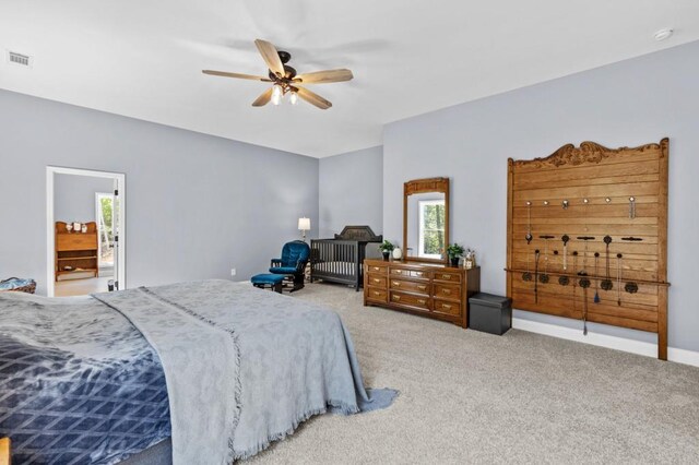 carpeted bedroom with ceiling fan and ensuite bathroom