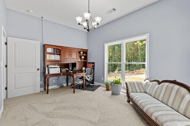 home office featuring a chandelier and light colored carpet