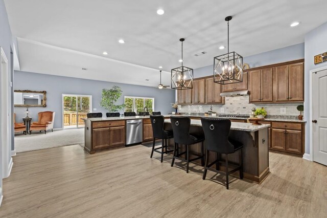 kitchen with pendant lighting, light hardwood / wood-style floors, and a center island