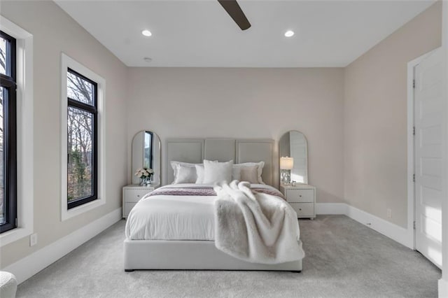 bedroom featuring light colored carpet and ceiling fan