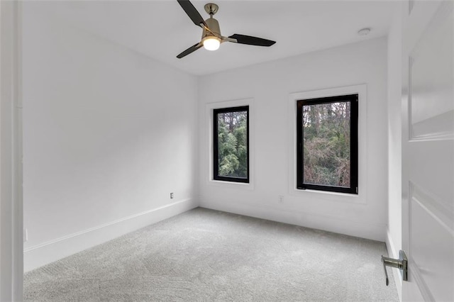 empty room featuring ceiling fan and carpet