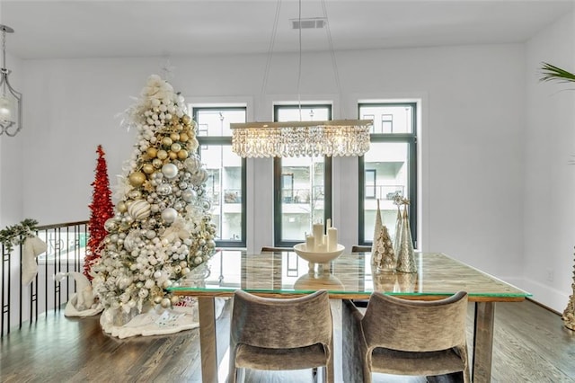 dining area with an inviting chandelier and hardwood / wood-style floors