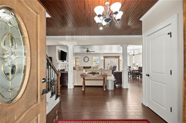 foyer entrance featuring dark hardwood / wood-style floors, ornamental molding, ceiling fan with notable chandelier, and wood ceiling