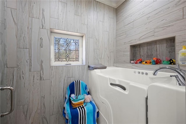 laundry area featuring tile walls