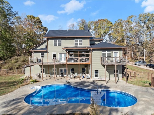 back of house featuring a patio area and a balcony