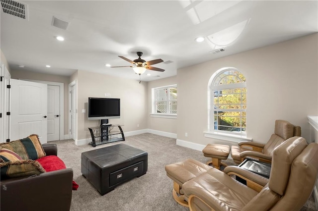 living room with light colored carpet and ceiling fan