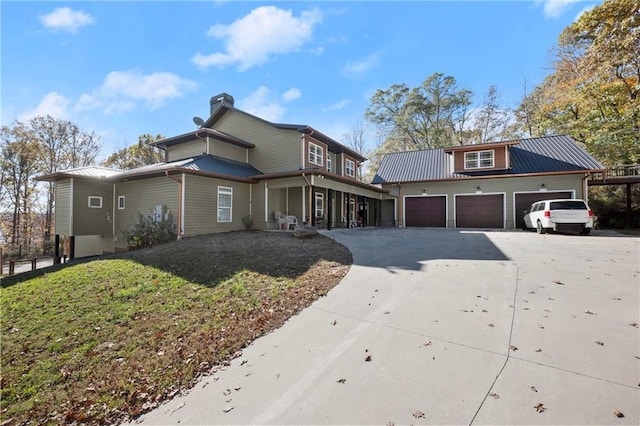 view of property featuring a front yard and a garage