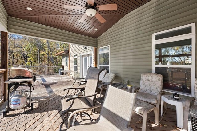 wooden terrace featuring ceiling fan and a grill