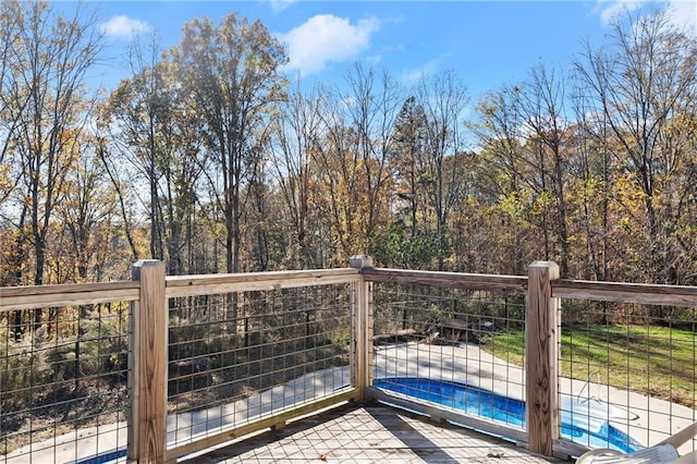 wooden deck with a swimming pool