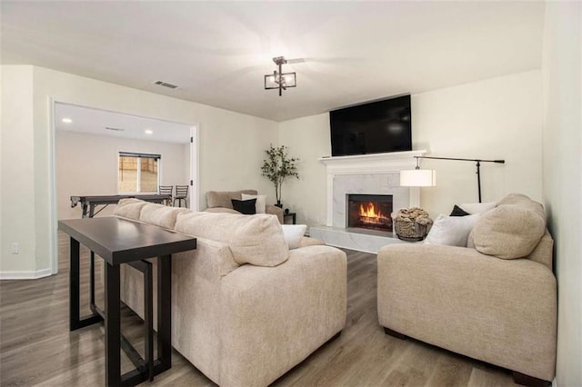 living room featuring hardwood / wood-style flooring and a fireplace