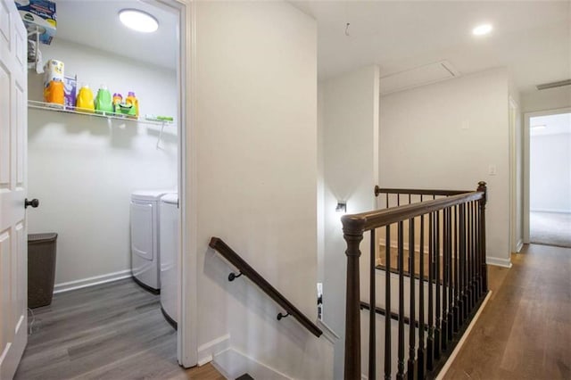 stairway featuring hardwood / wood-style flooring and washing machine and dryer