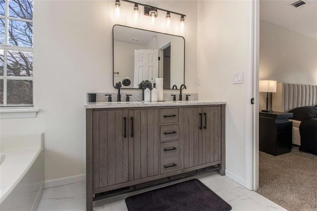 bathroom featuring a tub to relax in and vanity