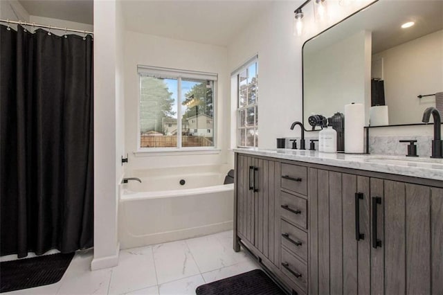 bathroom with vanity and a bath