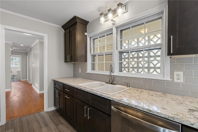 kitchen featuring decorative backsplash, dark wood finished floors, dishwasher, ornamental molding, and a sink