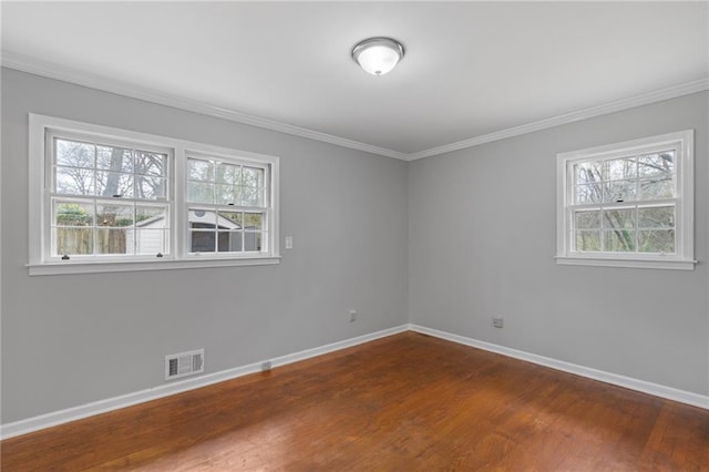 unfurnished room with plenty of natural light, baseboards, and visible vents