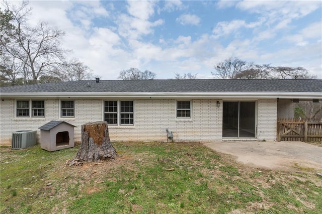 rear view of house featuring brick siding, a patio, and central air condition unit