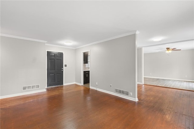 spare room with a ceiling fan, baseboards, visible vents, and hardwood / wood-style floors