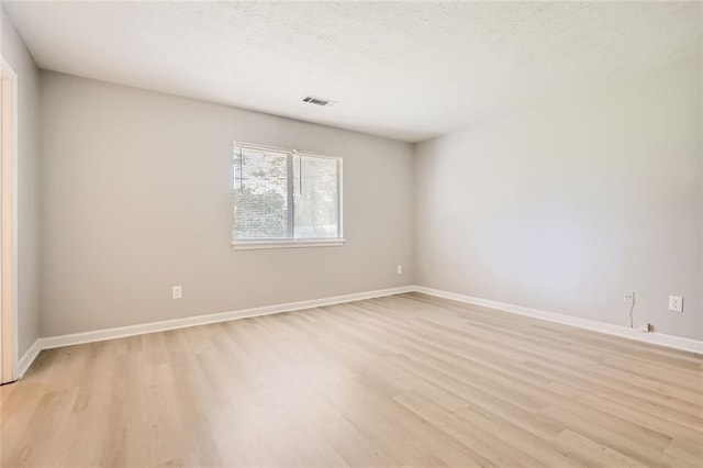 2638 Fieldstone View Ln SE, Conyers, GA 30013 - spare room with light wood-style flooring and a textured ceiling