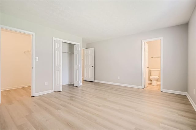 2638 Fieldstone View Ln SE, Conyers, GA 30013 - unfurnished bedroom featuring light wood finished floors, a closet, and ensuite bath