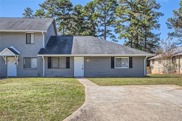 2638 Fieldstone View Ln SE, Conyers, GA 30013 - view of front of home featuring a front yard, brick siding, and a shingled roof