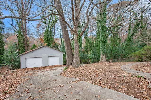 view of yard with a garage and an outbuilding