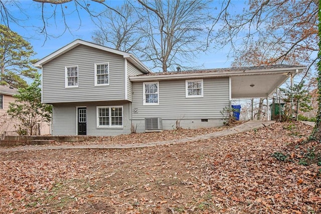 rear view of property featuring cooling unit and a carport