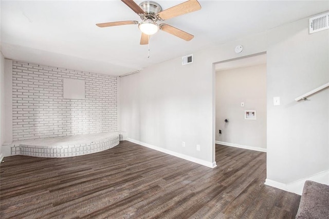 unfurnished room featuring ceiling fan and dark wood-type flooring