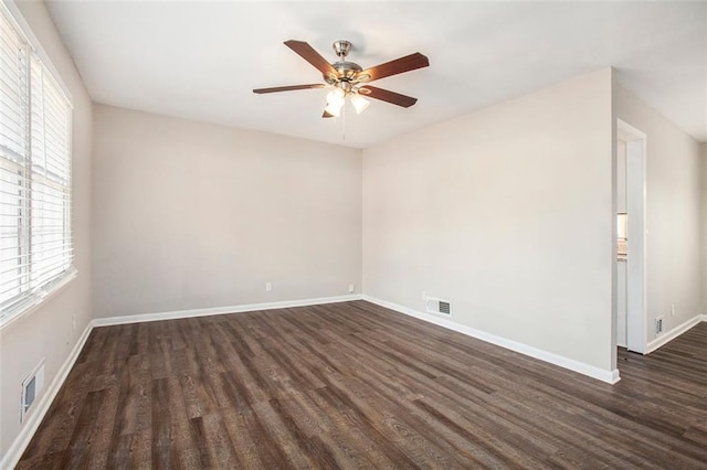 spare room with ceiling fan and dark hardwood / wood-style flooring